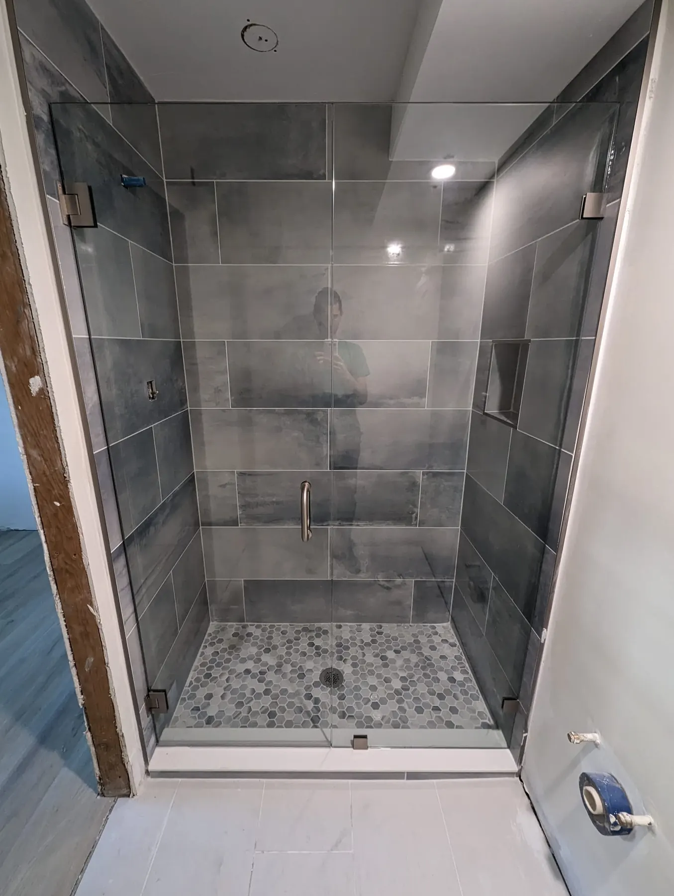 after frameless swing shower glass with brushed nickel hardware in Southwest Florida