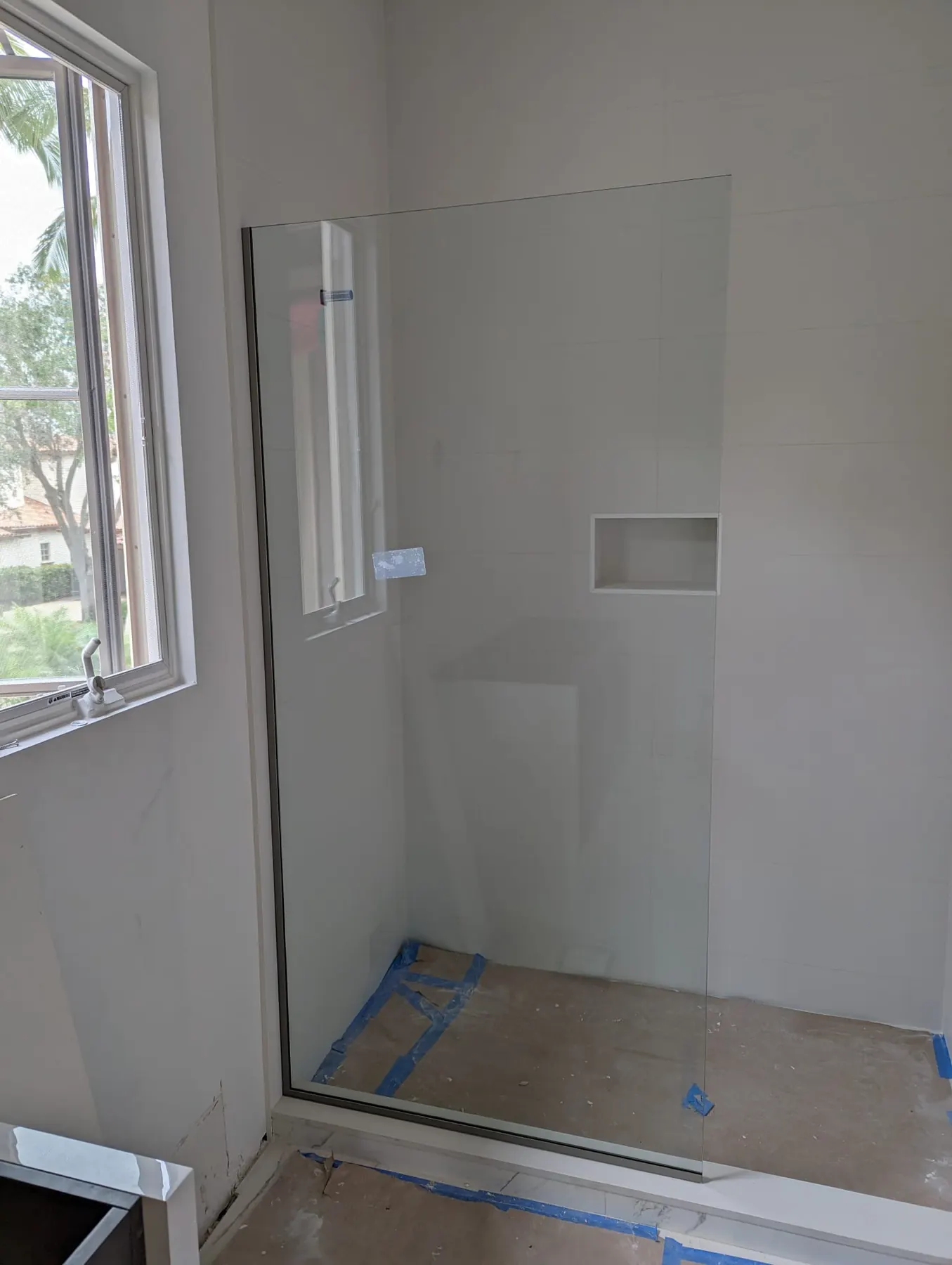 after frameless shower glass with brushed nickel hardware in Southwest Florida