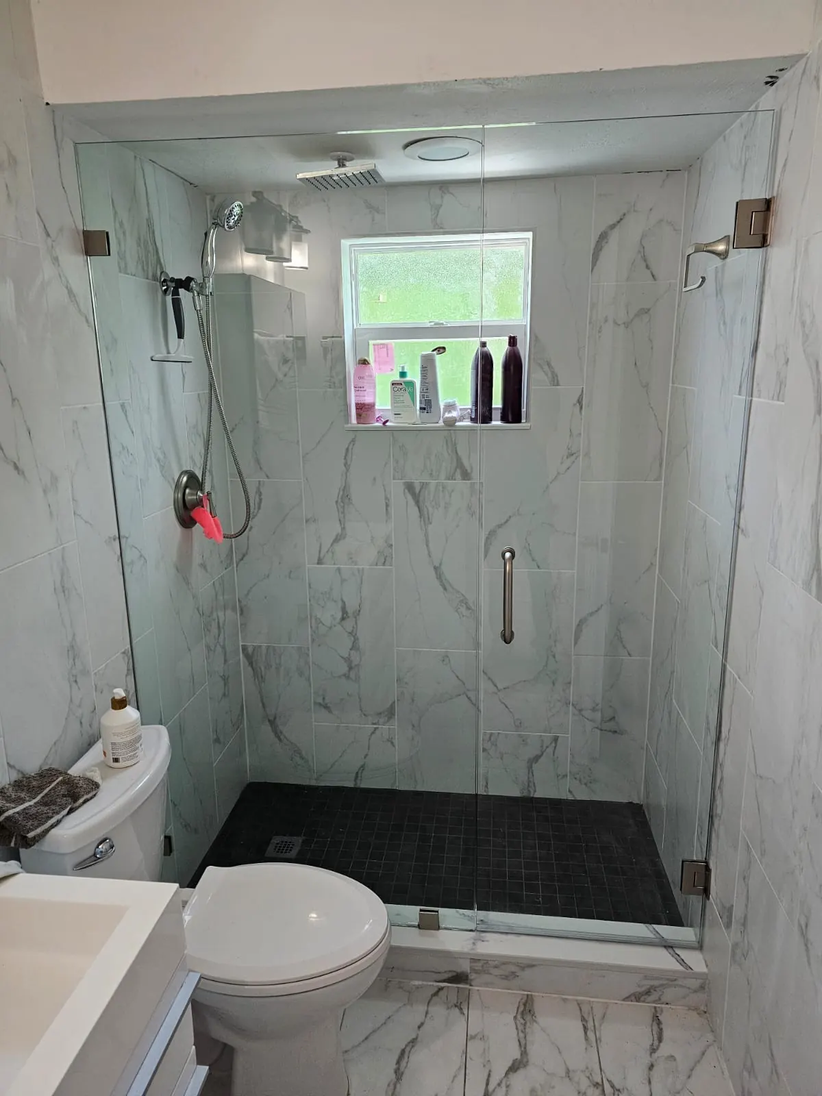 after frameless swing shower glass with brushed nickel hardware in Southwest Florida