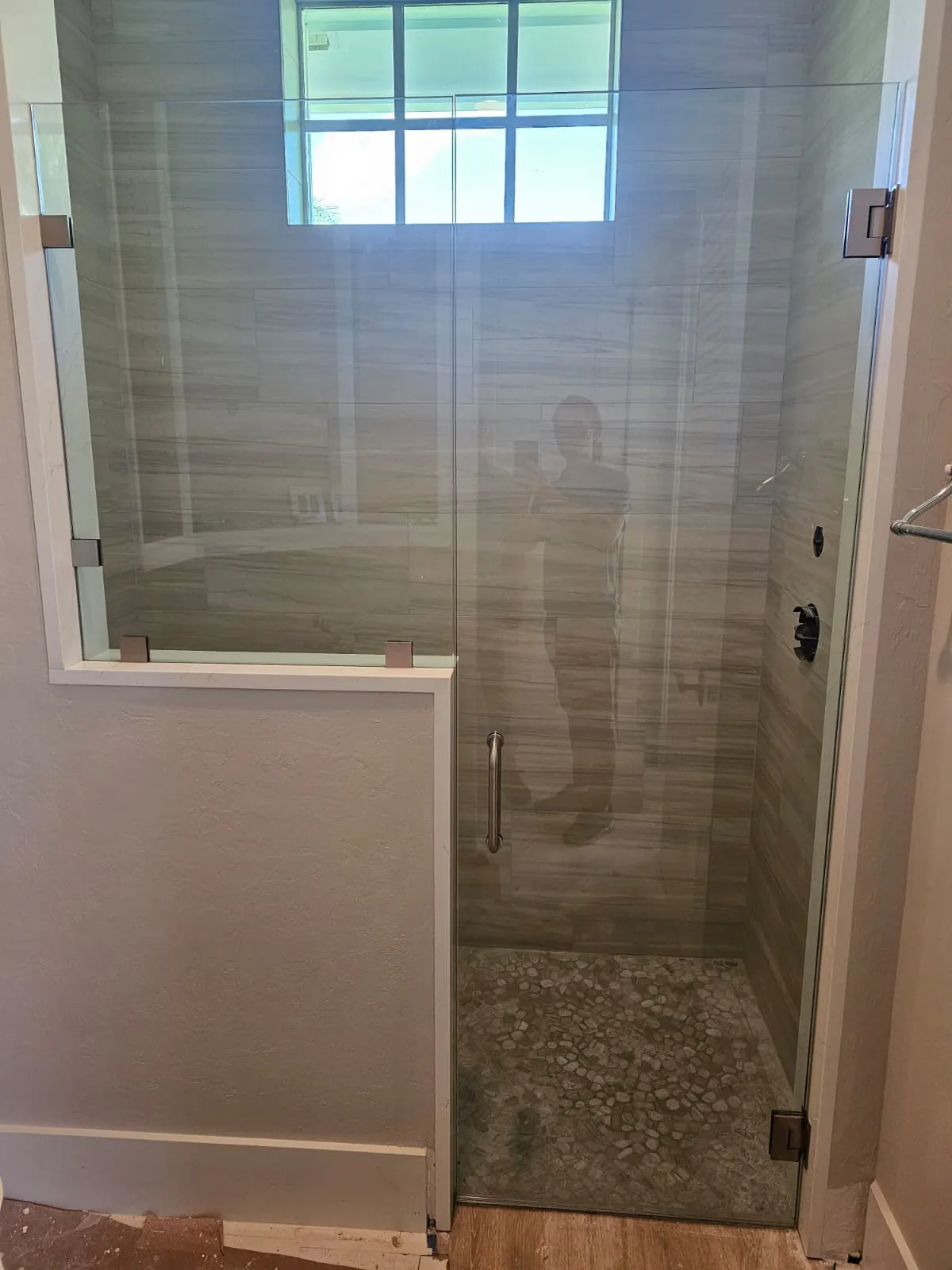 after frameless swing shower glass with brushed nickel hardware in Southwest Florida