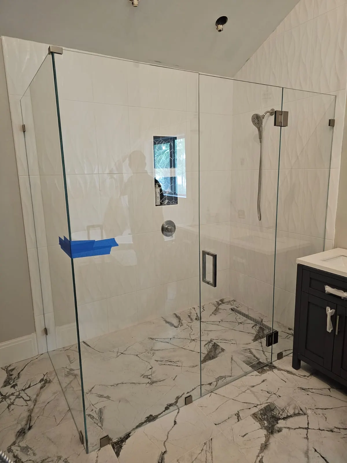 after frameless swing shower glass with brushed nickel hardware in Southwest Florida