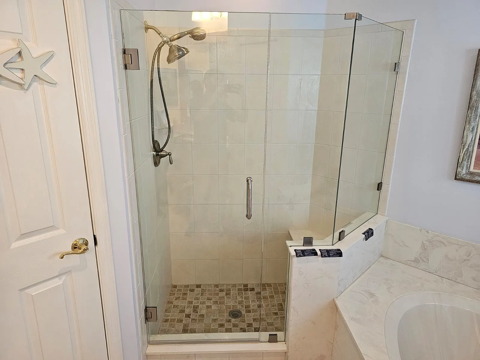 after frameless swing shower glass with brushed nickel hardware in Southwest Florida
