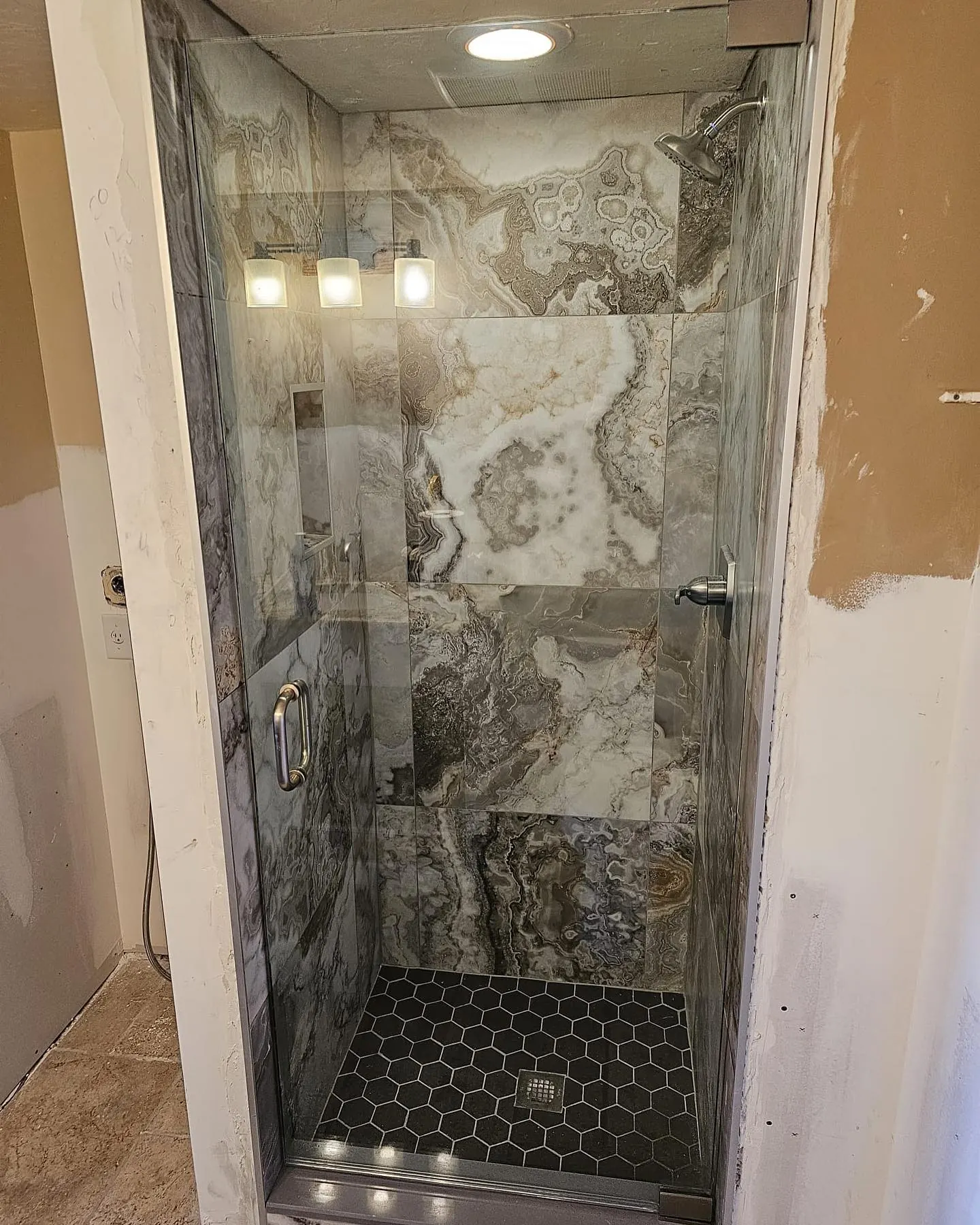 after frameless swing shower glass with brushed nickel hardware in Southwest Florida