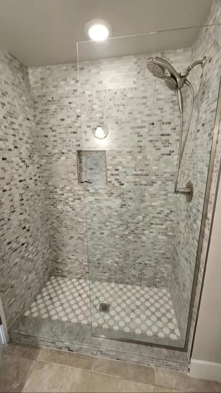 after frameless shower glass with brushed nickel hardware in Southwest Florida