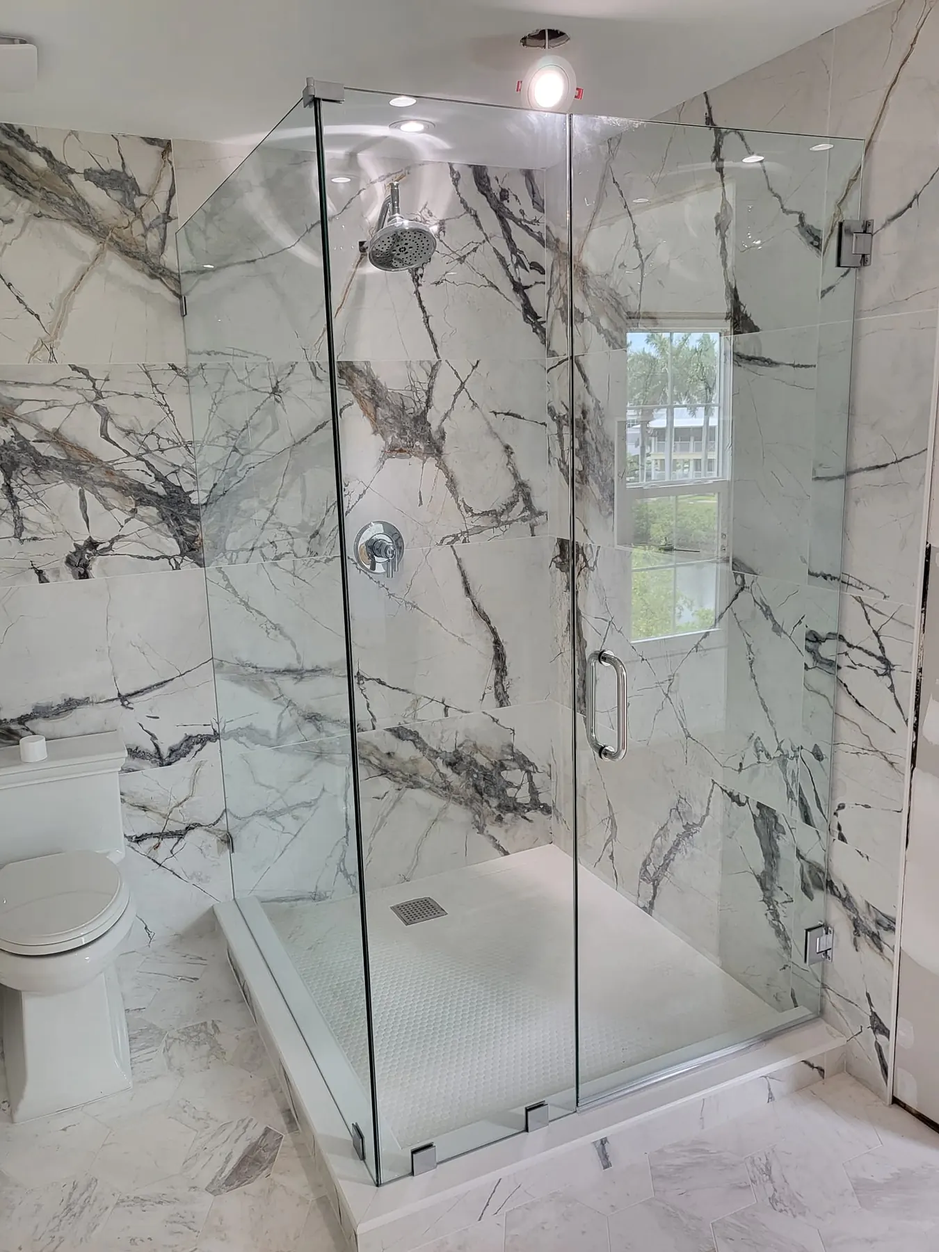 after custom swing shower glass with chrome hardware in Southwest Florida