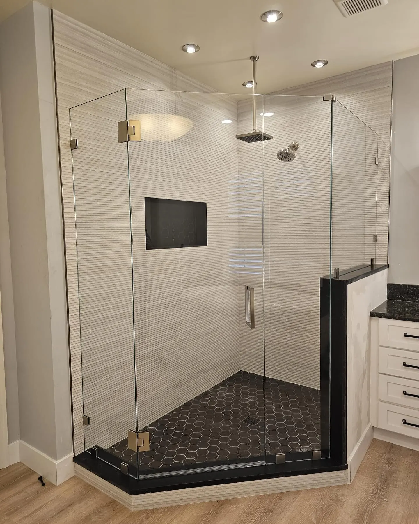 after frameless swing shower glass with brushed nickel hardware in Southwest Florida