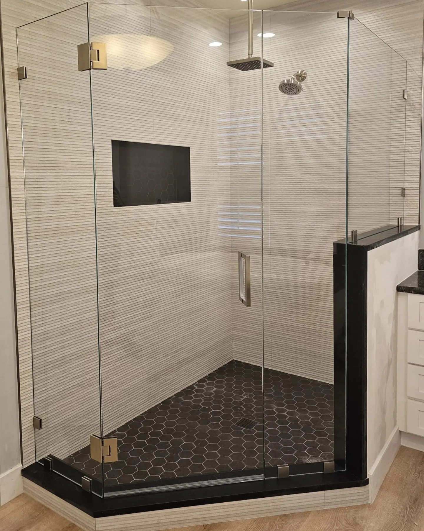 after frameless swing shower glass with brushed nickel hardware in Southwest Florida