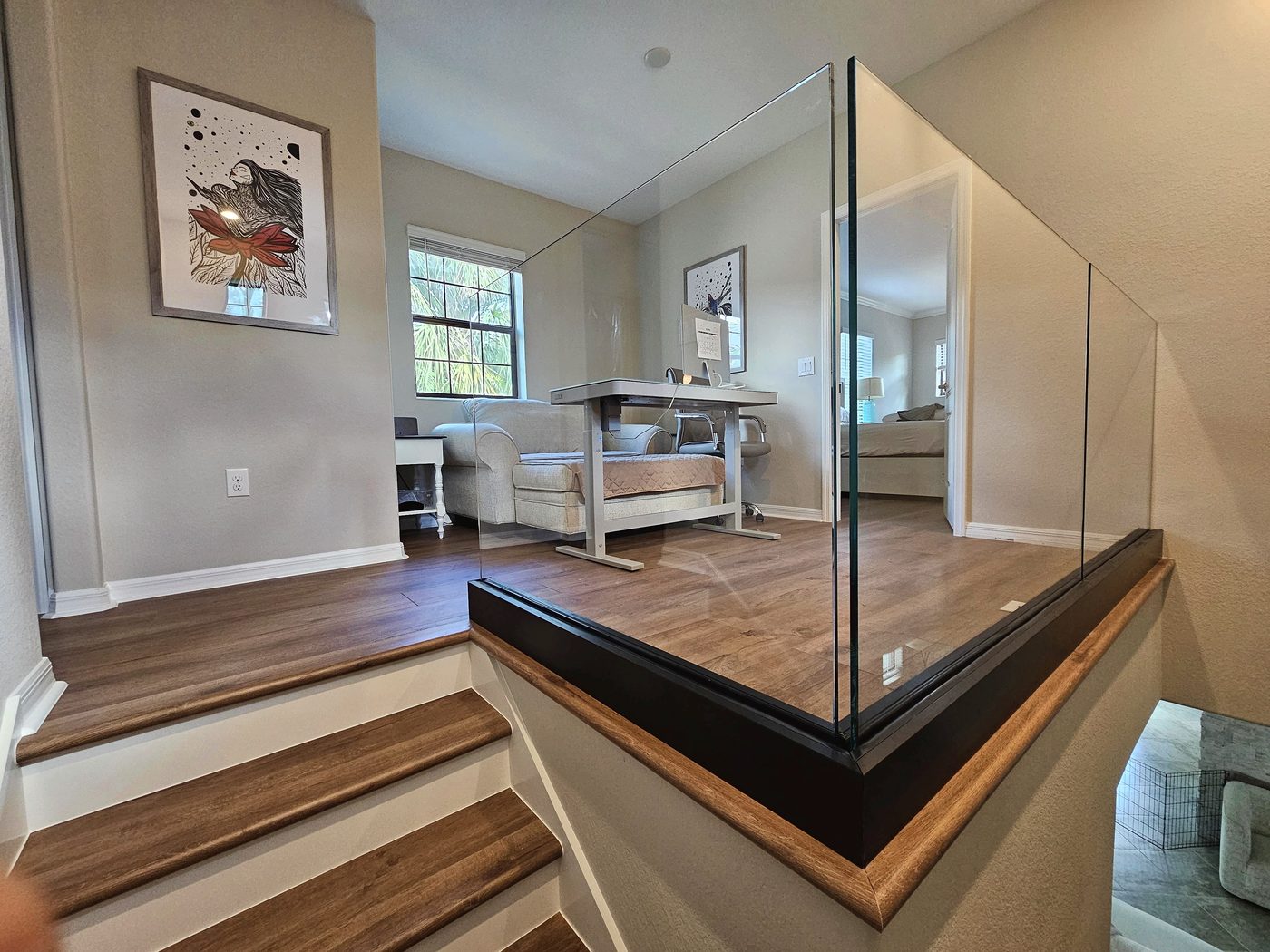 clear glass railing installed on an interior loft staircase in a Southwest Florida home