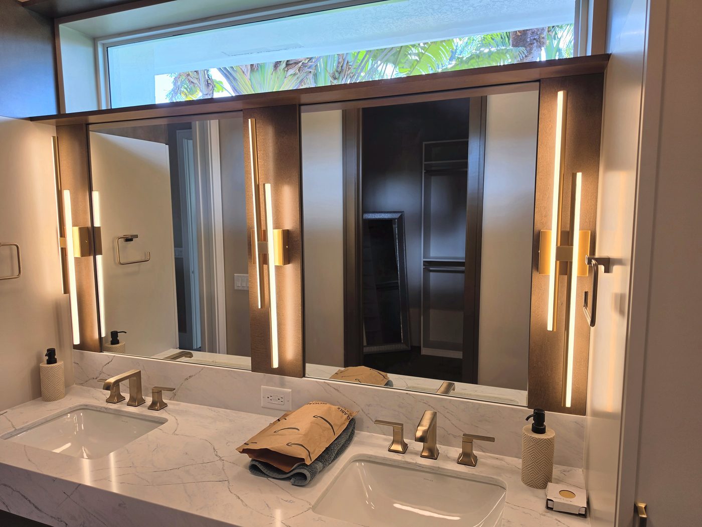 custom lighted vanity mirror installed above a double sink in a Naples bathroom remodel